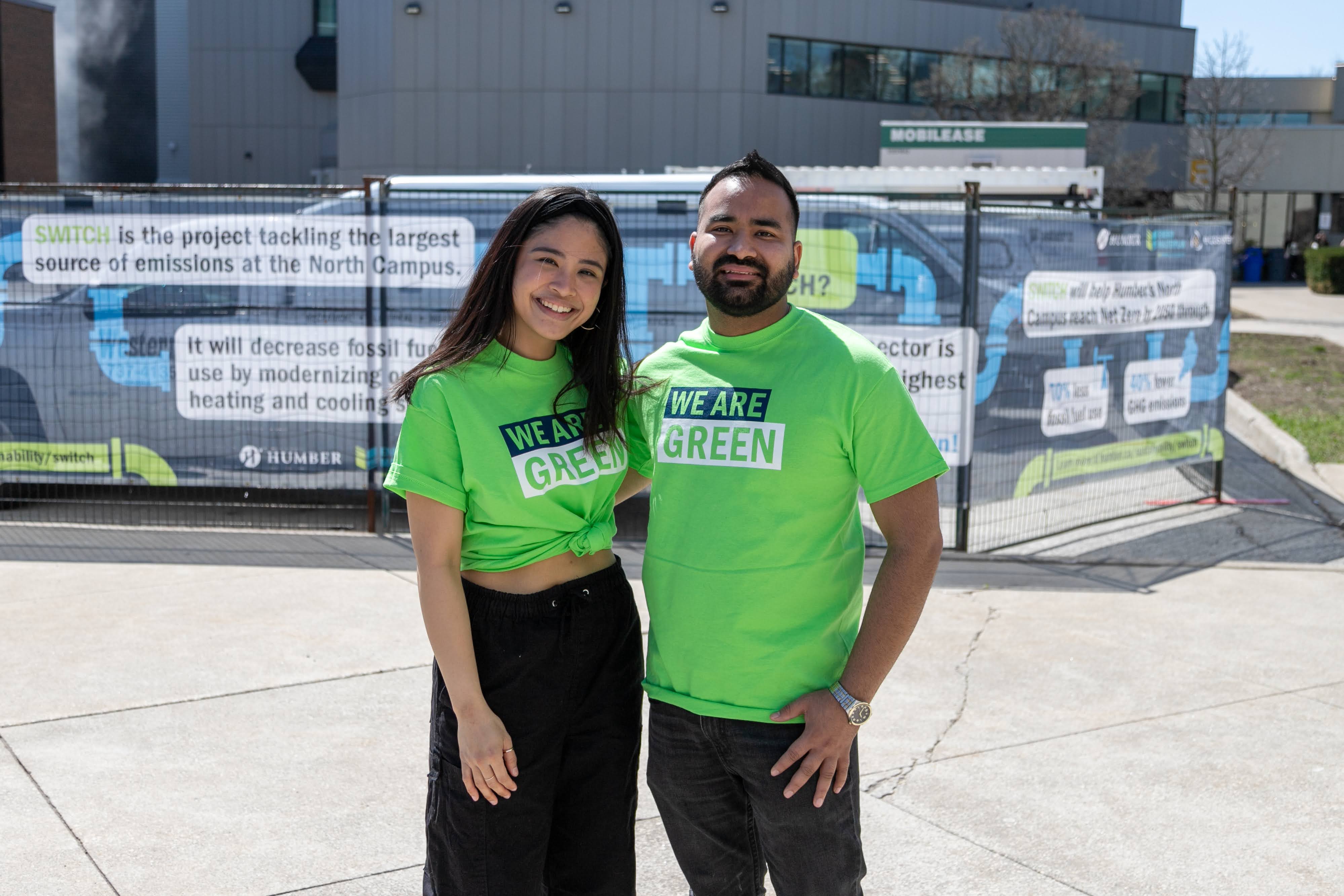 A man and a woman standing in front of a Humber building